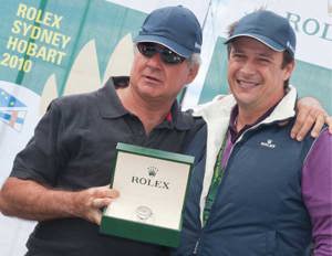 Geoff Boettcher accepts his Rolex Yacht Master timepiece from Patrick Boutellier, Rolex Australia