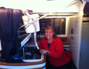 Julie Hodder, navigator on Exile, with her re-modelled nav station - trying to avoid water damage from when water spills over during big winds and seas
