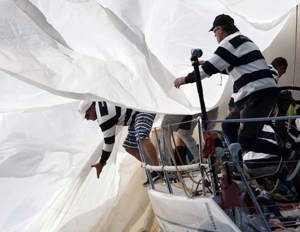 Andrew Short's Pricewaterhouse Coopers retrieving their spinnaker during the start of Audi Sydney Gold Coast Yacht Race