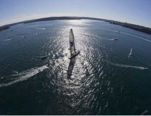 Wild Oats XI leaving Sydney Harbour with some spectators in her wake