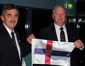 Immediate Past Commodore Clive Simpson presenting newly elected RYCT Commodore Graham Taplin with his burgee