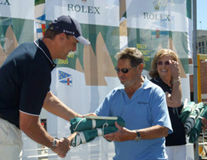 Lou Abrahams, skipper of Challenge, accepts the divisional winners battle flags from Matteo Mazzanti of Rolex