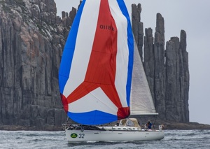 Samskara passes the organ pipes at Cape Raoul sailing to Hobart