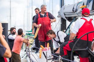 Frantic skipper Mick Martin breaking bread with his winning team at the dock on Noumea