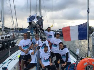 The crew of 41 SUD celebrate their arrival at the finish in Noumea