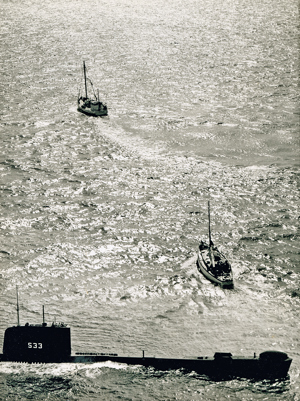 Lolita's tow being assumed by a fishing trawler, after initially being towed by HMS Trump