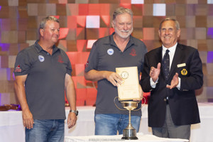 Andrew Nuttman and Anthony Kirke (owners/skippers, Enterprise Next Generation) collect the Seamanship Award from Arthur Lane (Commodore, CYCA).