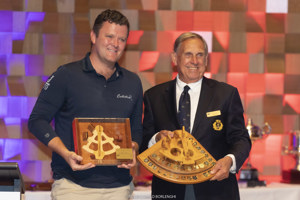 James Dagge (navigator, Celestial) is presented the Bill Owen Memorial Trophy by Arthur Lane (Commodore, CYCA).