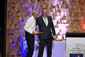 Bruce Gould being presented with his '50 race' medallion by Minister Nic Street.