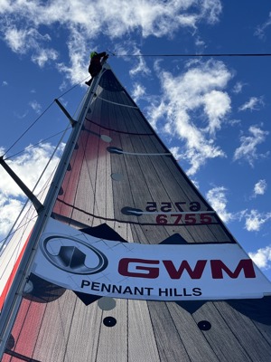 Crew member either seeking a better view or tending to an issue up the mast of Ian Creak's Beneteau 47.7 GWM Pennant Hills.
