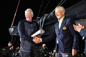 LawConnect sailing master Tony Mutter being congratulated by CYCA Vice Commodore David Jacobs.   Image: CYCA | Salty Dingo
