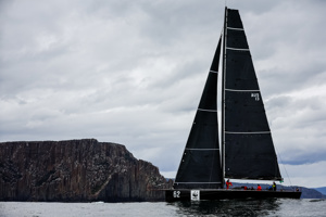 Whisper crawling past Cape Raoul.   Image: CYCA | Salty Dingo