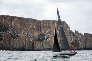 Caro with the spectaculr backdrop of Cape Raoul.     Image: CYCA | Salty Dingo