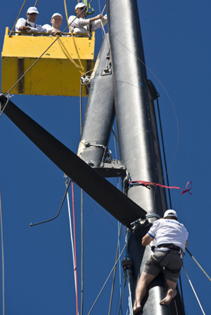 The broken top section of Skandia's mast being removed in Hobart