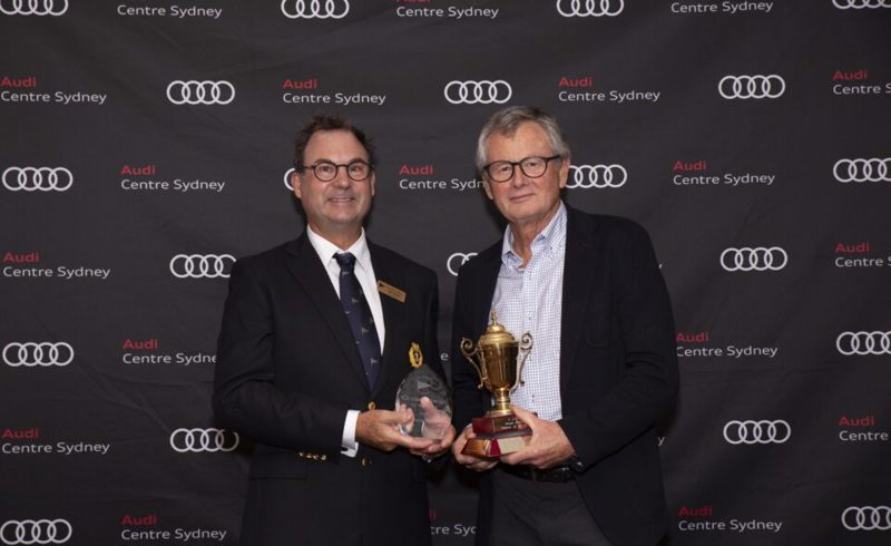 Bruce Taylor receiving his award from Rear Commodore Dr Sam Haynes