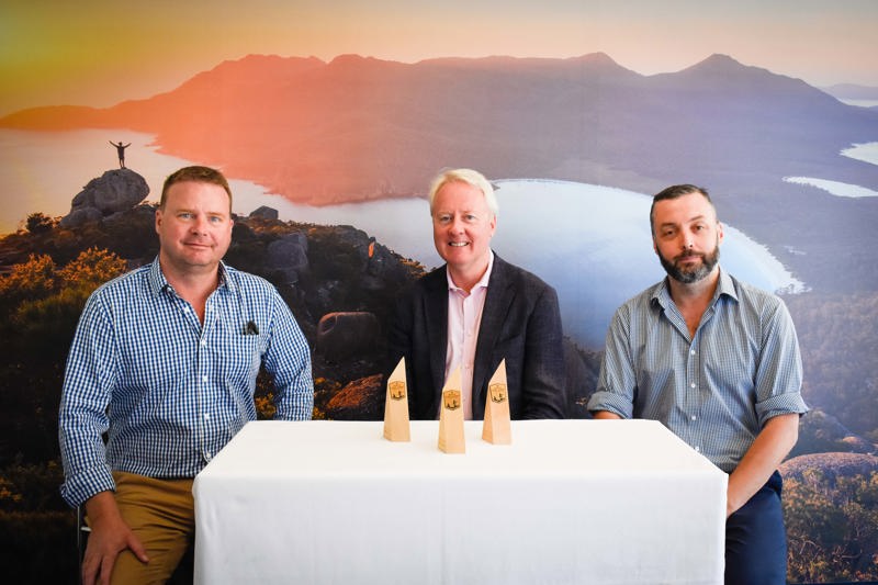 (From left to right) David Wise - Director Hydrowood, John Fitzgerald - CEO Tourism Tasmania, and Andrew Morgan - Director Hydrowood with the commemorative mementos that will be provided to all competitors in the 2019 Rolex Sydney Hobart Yacht Race. 